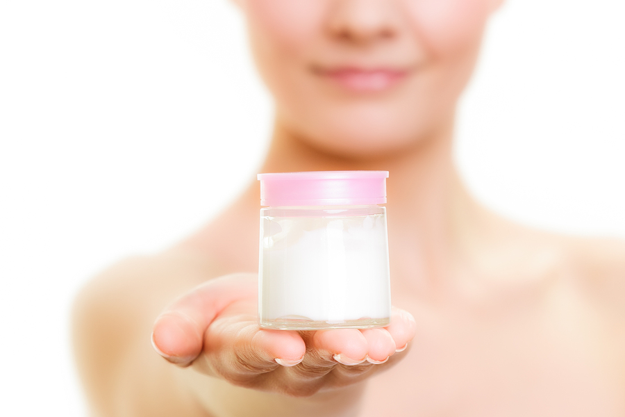 Skin Care. Girl Applying Moisturizing Cream.